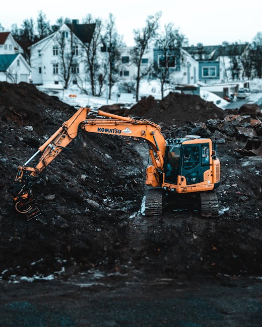 A Komatsu excavator working on a snowy construction site in Tromsø, Norway.